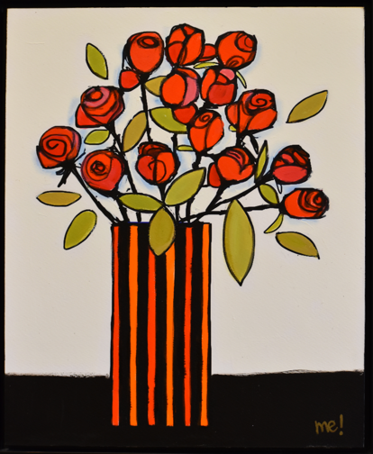 A red striped vase holding flowers